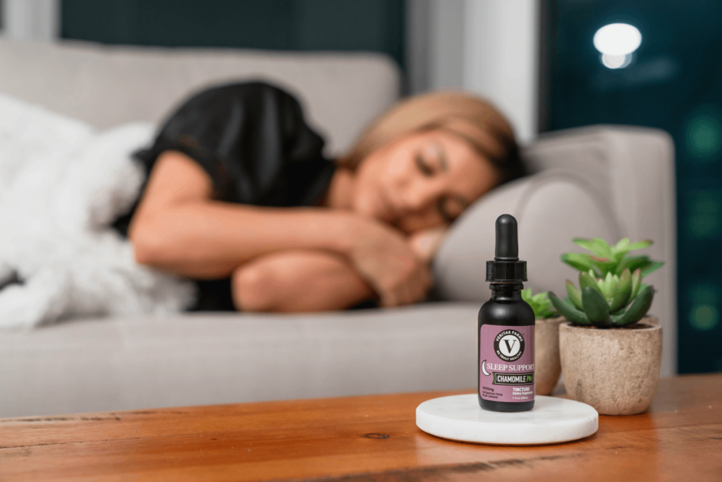 Woman Sleeping in the Background and Veritas Farms Sleep Support Tincture | Veritas Farms